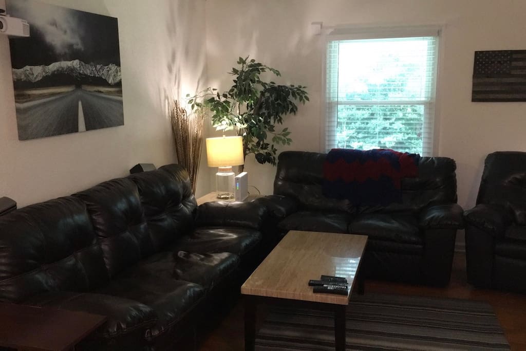 Large Living Room with a Full size couch, love seat and recliner. 40" TV and Projector are available in the living room.