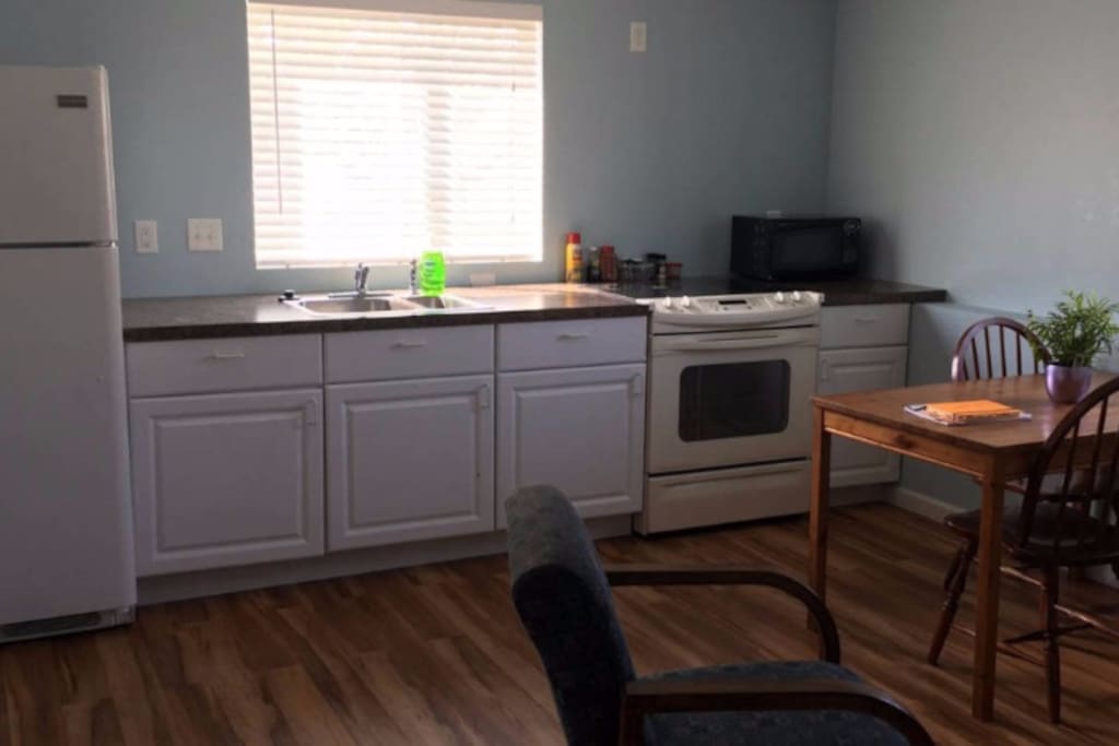 Fully equipped kitchen includes a full size fridge/freezer, oven range, and microwave. Pans, dishes, and utensils available.