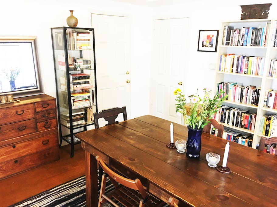 Large Dinning Room includes a side Patio. Solid wood table and midcentury hutch table.