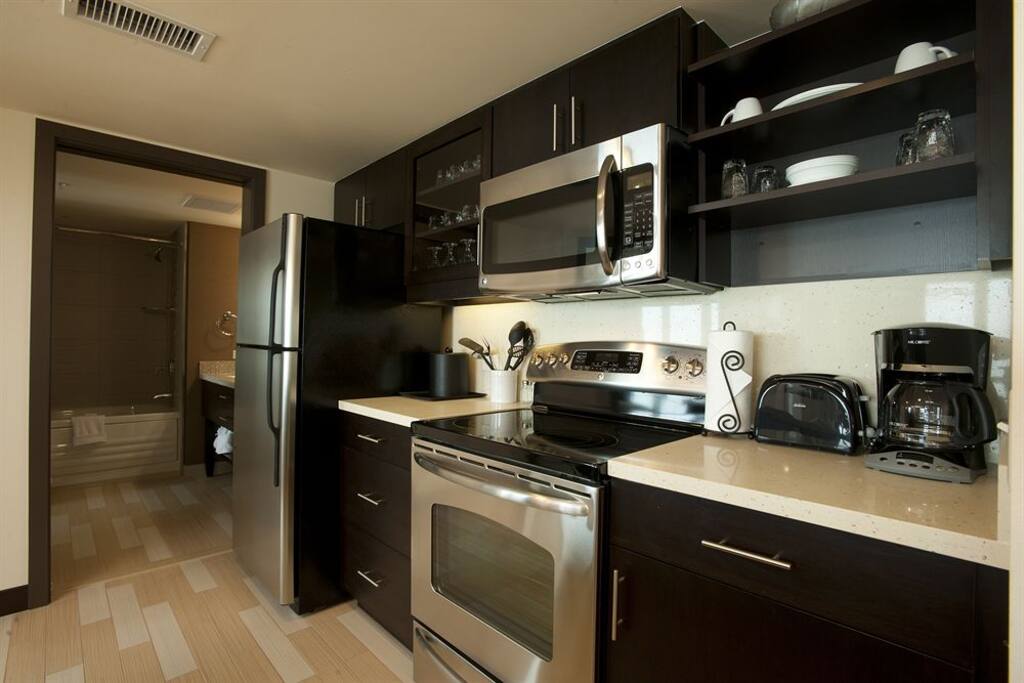 Full kitchen including oven, microwave, microwave, dishwasher, and basic kitchen electronics, cookware, and eating/cooking utensils.