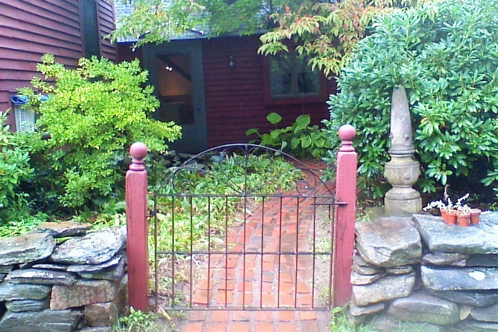 Entry through gateway, brick path.