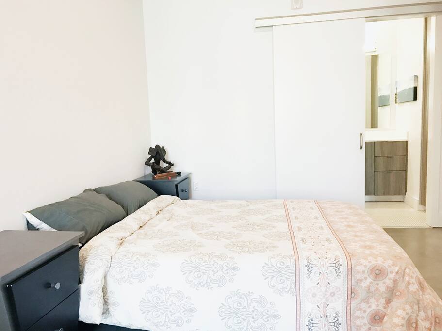 Bedroom with two nightstands, bathroom and a large closet