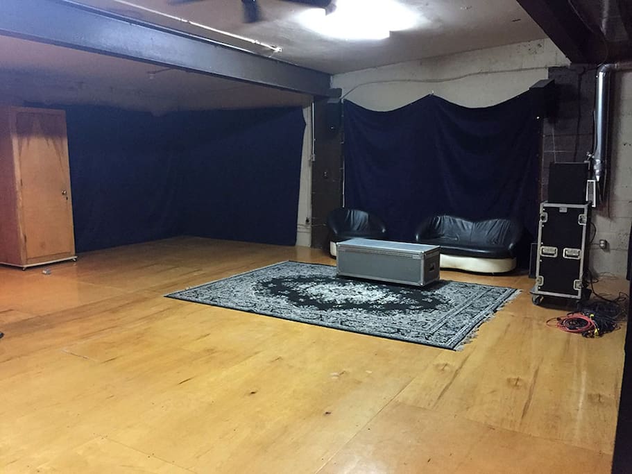 Big space, high ceilings, big window behind curtain