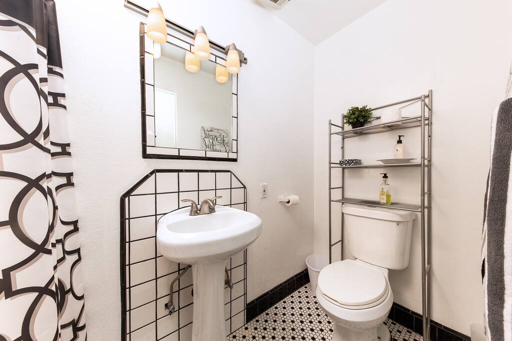 This quaint black-and-white bathroom is the perfect addition to the apartment, making it a two bedroom and two bathroom space.