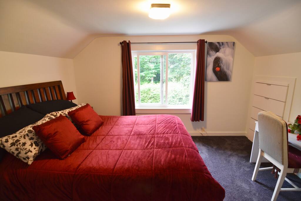Main bedroom with view from window in summer.