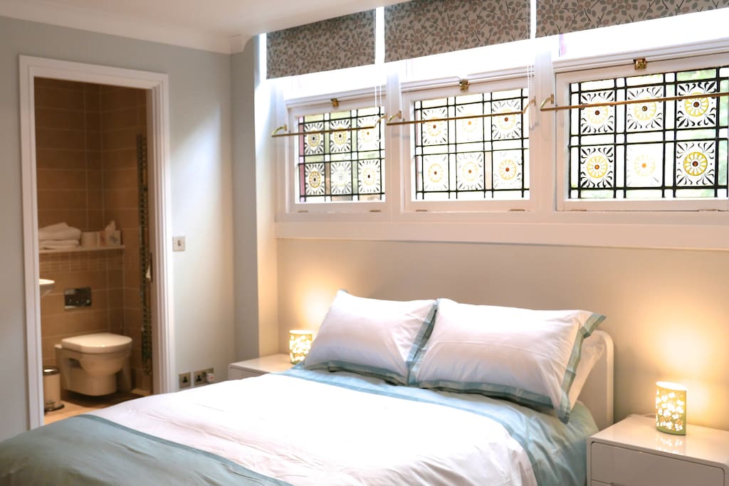 Master bedroom with en-suite shower room, fitted wardrobes, stained glass windows, high quality bedlinen and blinds by renowned designer Natasha Marshall.