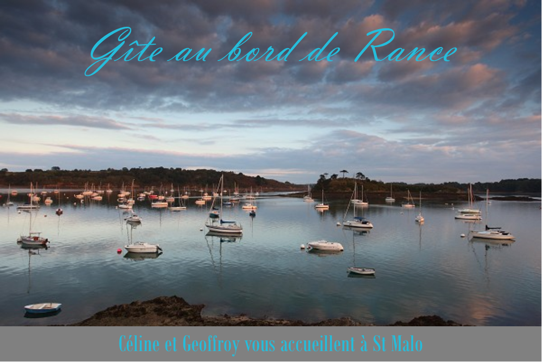 A tranquil view of the Rance river is presented, with several boats anchored on the still water. The sky features an array of clouds, reflecting soft colors from the sunset. The landscape includes greenery and distant landmasses, creating a serene coastal scene.