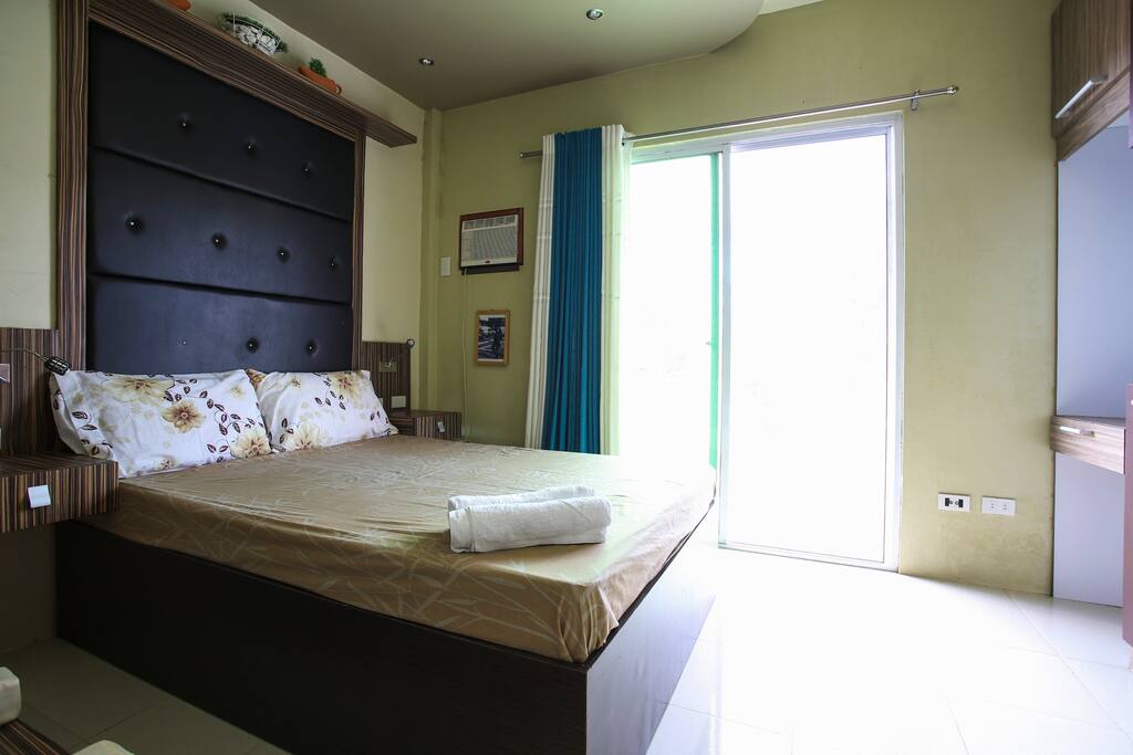The master bedroom with access to the balcony