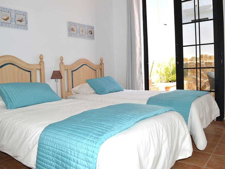 Lower level twin beds with walk out private terrace