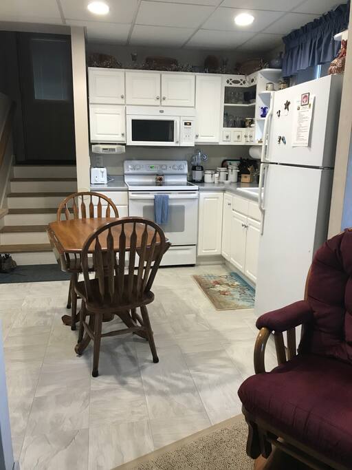 Standing in living room facing the kitchen and entry.