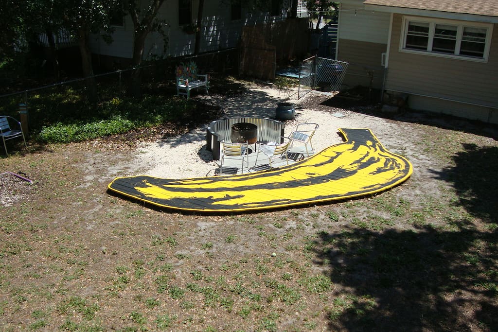 "The Banana!" A custom built deck adorns the large fenced-in backyard complete with fire pit.