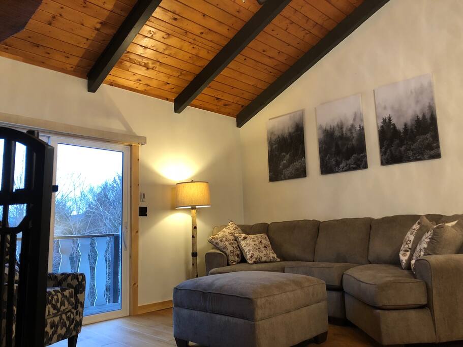 Upstairs living room with comfy oversized couch and fireplace