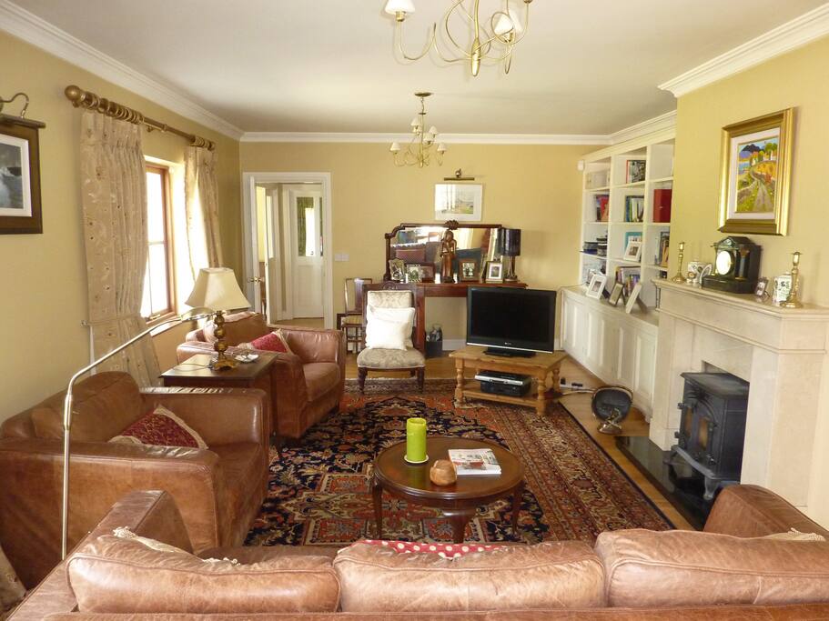 Guest's Lounge with wood burning stove and TV.