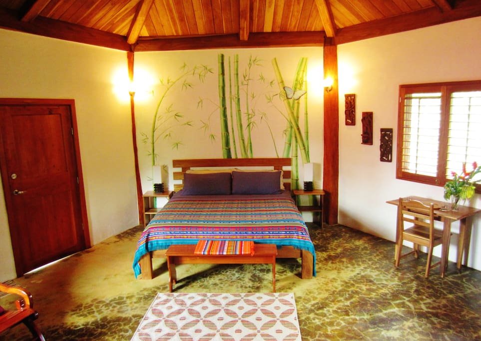 Beautiful bamboo mural by local artist, Ulani. King sized quality mattress and linens. Hand woven artisanal blankets.
