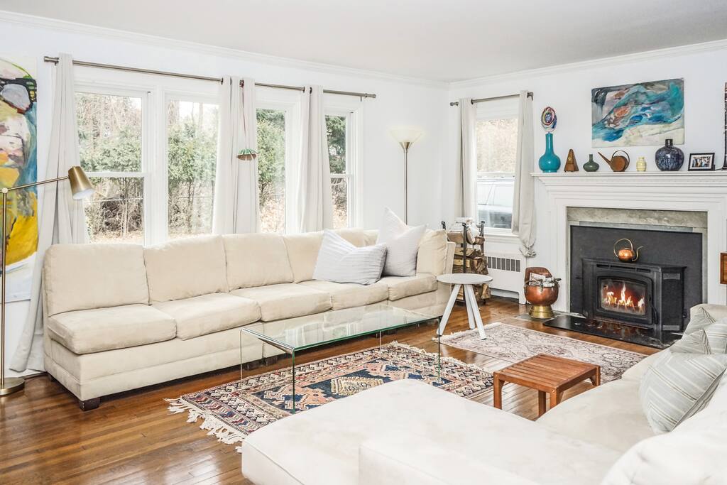 Living room has two large couches, large picture window and flat screen HD tv