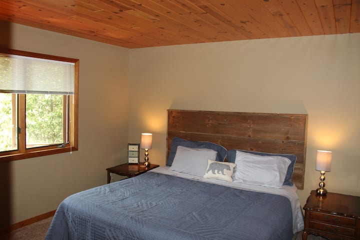 Upper Level Bedroom 1 with King, lake view, and custom made headboard by owner