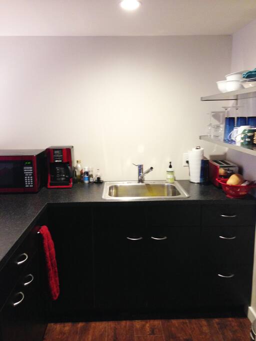 The efficient kitchen includes everything to prepare meals: a two-burner gas cooktop (not shown)
Microwave
Small Refrigerator with freezer (shown next to the desk).
Coffee maker, and Toaster.