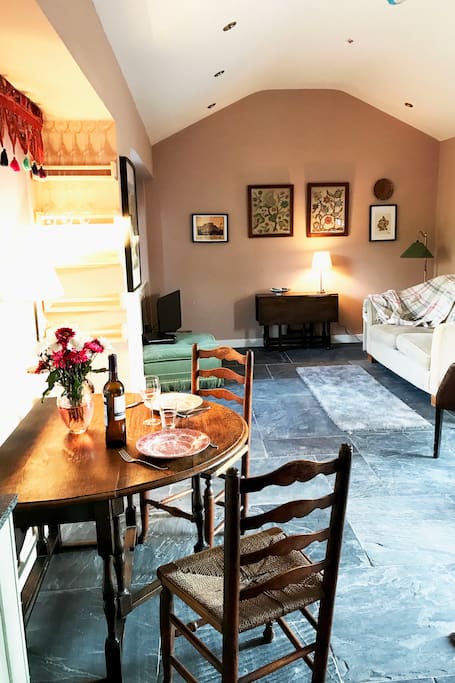 The living area of St Drogo's - open plan and light filled, characterful mix of antique and modern - designed for living.