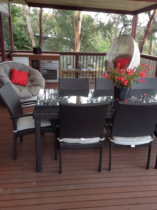 Large deck with bbq, bar fridge, outdoor oven and a great bush view
