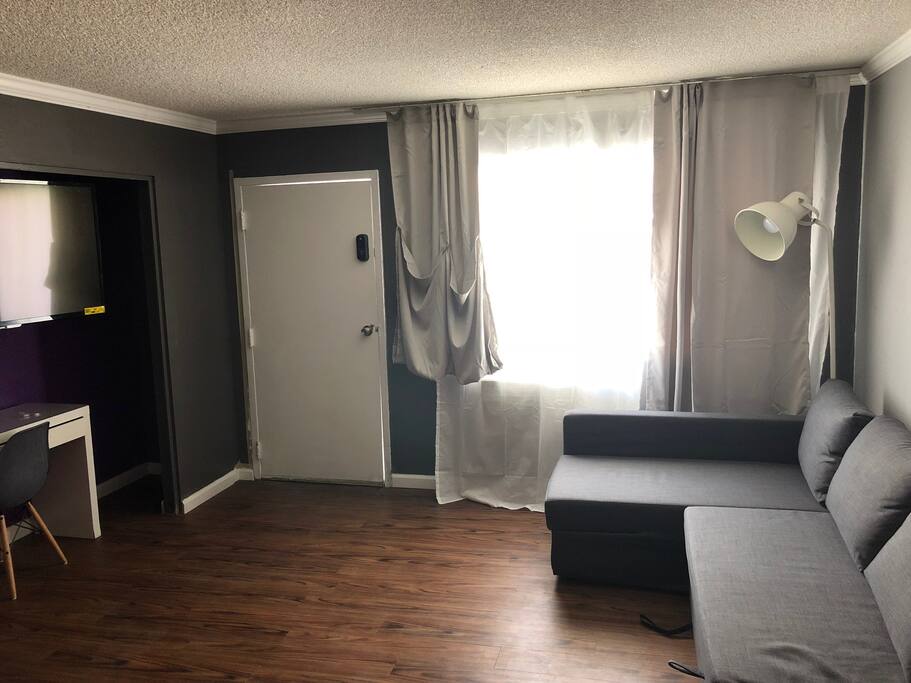55' Smart TV, Large, convertible couch, smart lock for easy access, black out curtains.