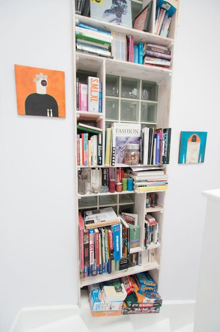 Library in hallway with books and games (you may read/use but please don't "borrow").