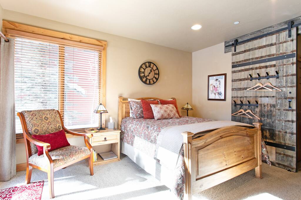 Bright and airy space with high ceilings featuring large custom barn door entry way