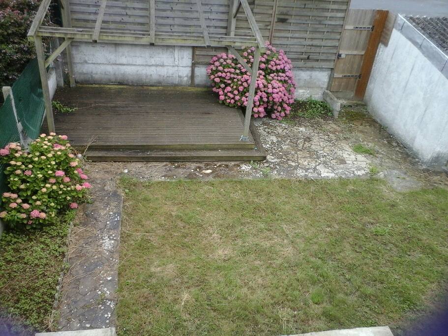 Une partie du jardin avec une terrasse