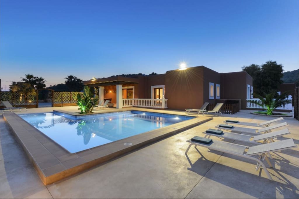 Spacious pool area with loungers for all