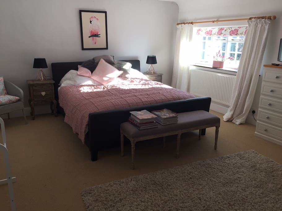 Your bedroom with a super king sized bed and lots of floor space.