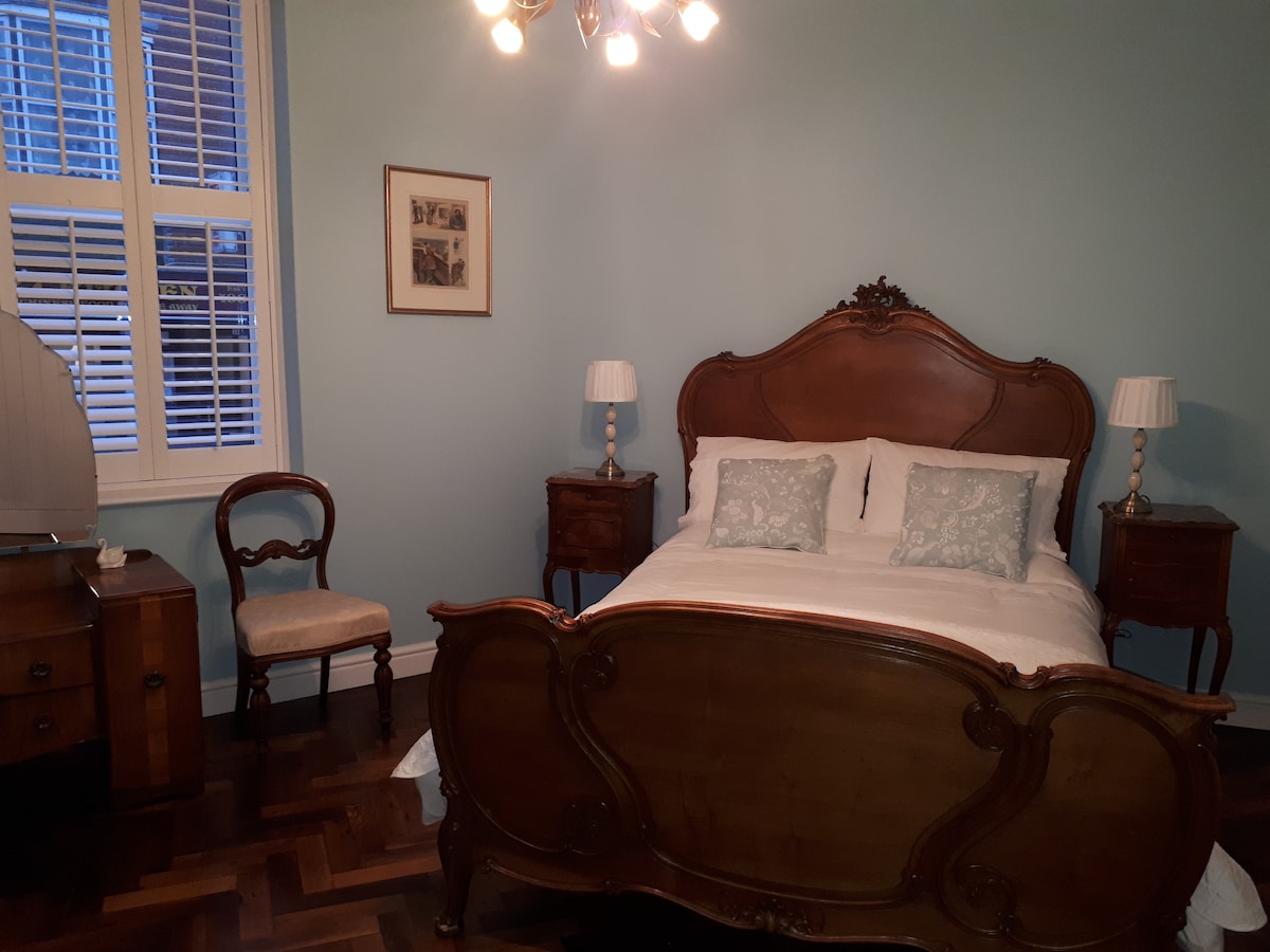 Double bedroom with antique French bed and furnishings.