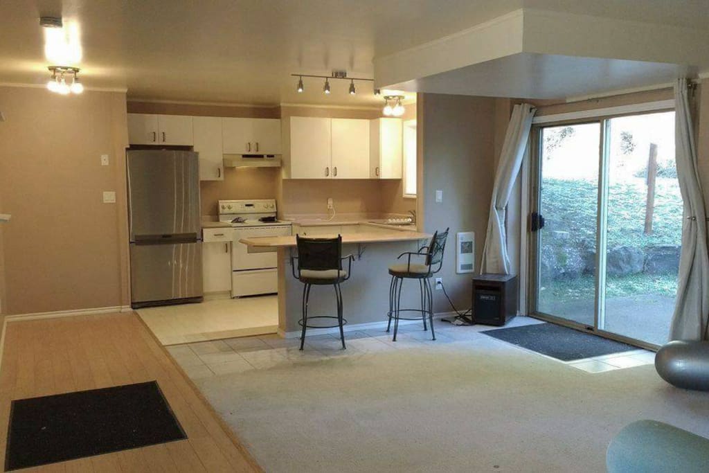 large open concept living space, patio door to fenced yard
