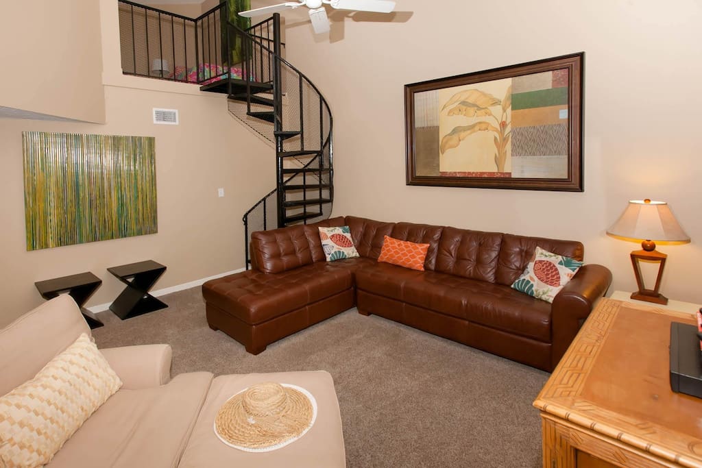 Sectional sofa, ceiling fan and spiral staircase to loft