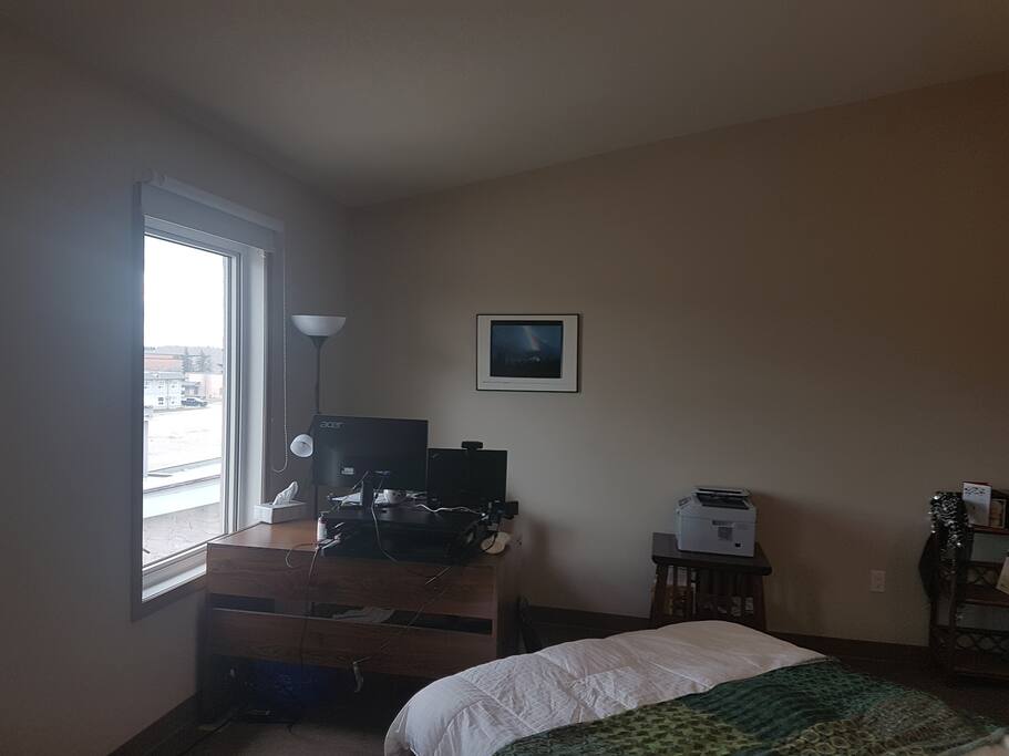 Glimpse outside of the master bedroom. On a clear day you can see the mountains from both windows in the bedroom. Desk will be clear for you to put your computer on it, or not.