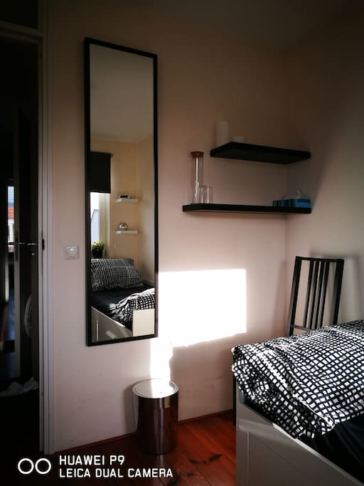 big mirror and chair and shelfs