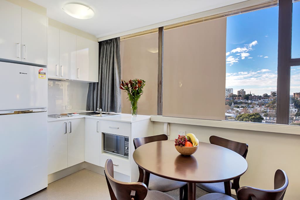 Full sized fridge/freezer, equipped kitchen and dining setting that doubles as a work station.