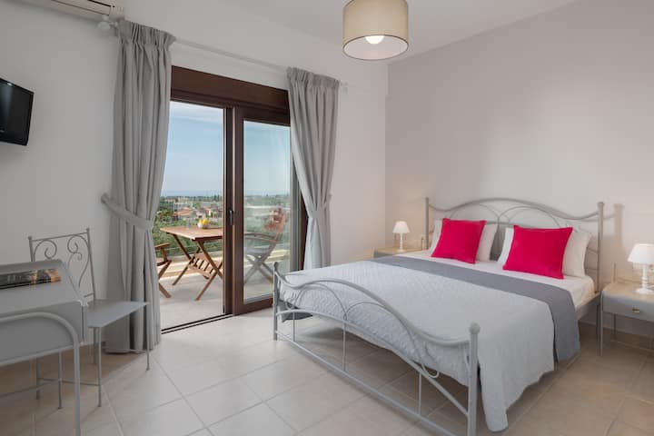 חדר שינה ראשי מואר ומלא באור טבעי רך.