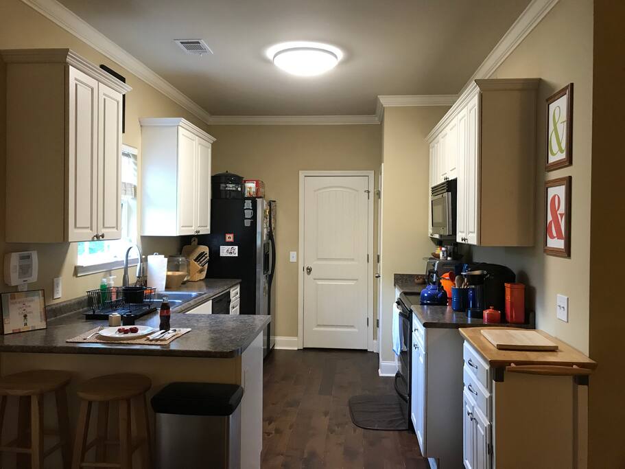 Our kitchen: ample space for food prep with a dual basin sink. We have a Keurig that you are free to use (we have refillable filters to cut down on environmentally unfriendly plastic K-Cup pods). We also have a variety of different teas as well!