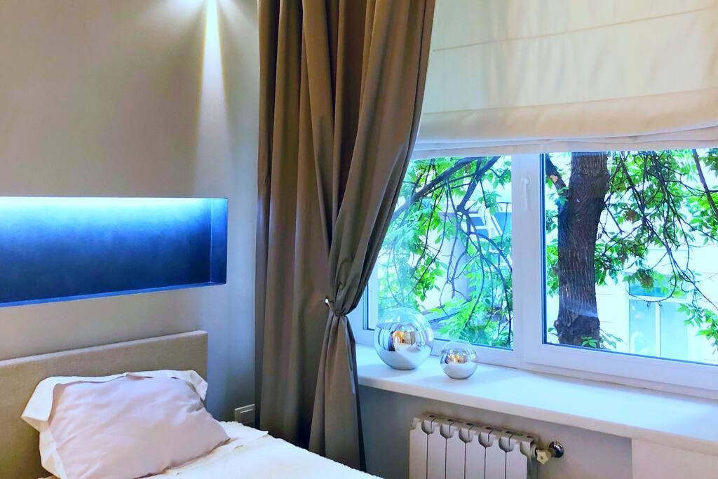 Quiet stylish bedroom with Windows in a quiet courtyard
