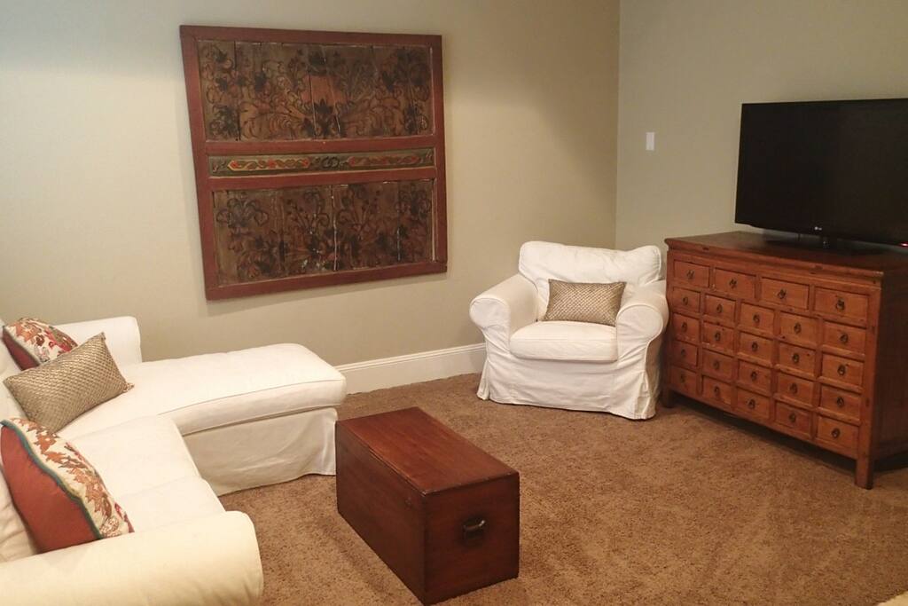 Living Room with sofa, chairs and TV.