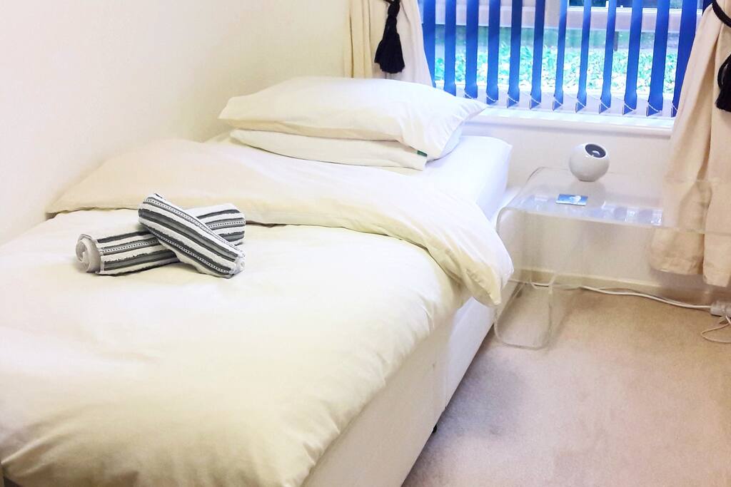 Comfy Bed with bedside table and lamp