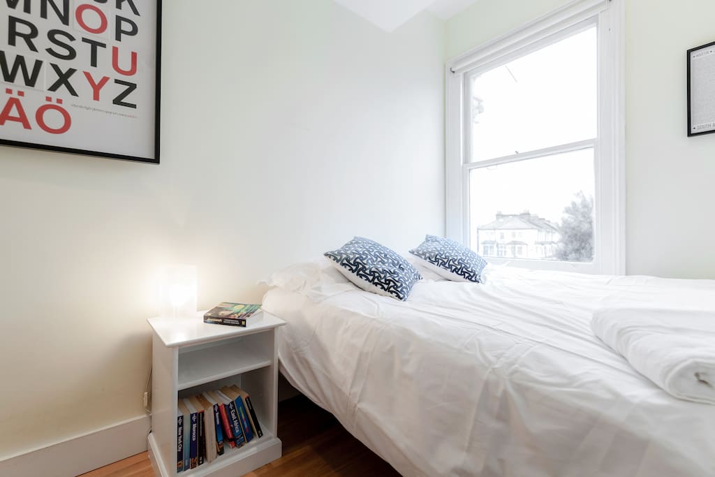 Your room - comfy king bed and side table for all your books