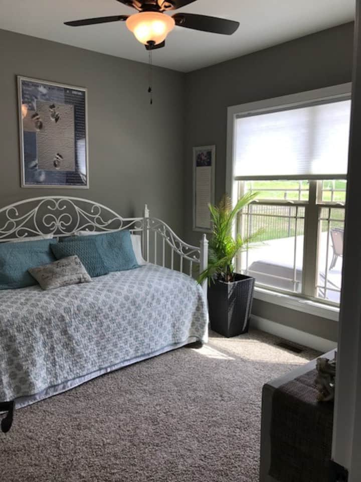 Aqua guest bed room/sun room, is a pool side room and part of the Nashville Suite. Both are side by side and located on the main floor behind the kitchen. Day bed, with pull out trundle underneath. Dresser w/bench and closet. 