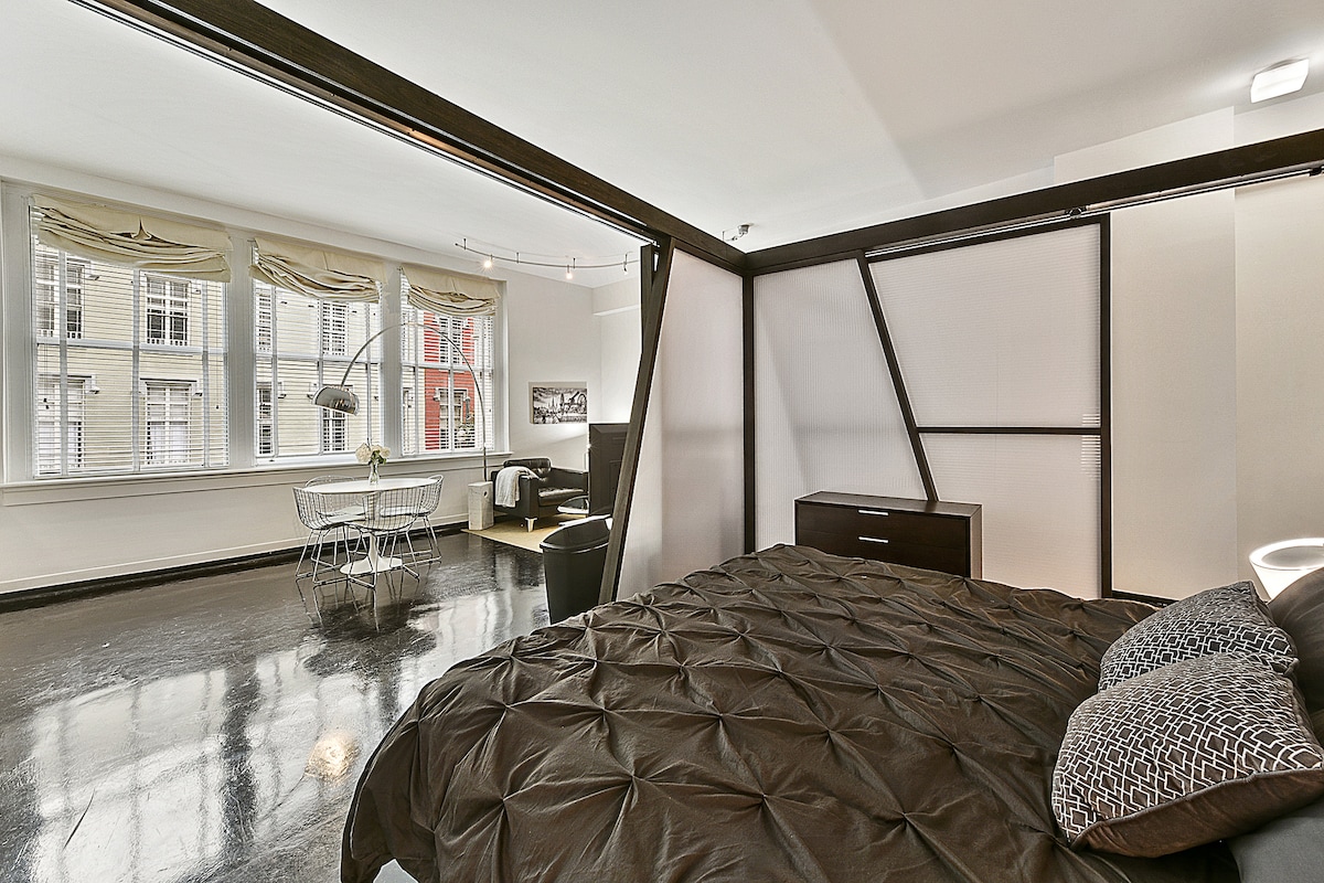 Relax in the cozy bedroom featuring a king-size bed with premium linens, soft lighting, and blackout curtains for a restful night’s sleep. Enjoy privacy and comfort in this stylish retreat, complete with a large closet and quiet, hotel-like vibes.