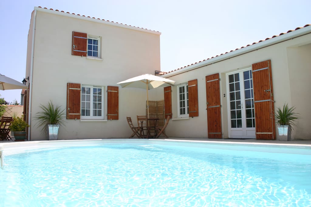 The exterior of the apartment (double door to right of image) leading out onto the shared pool