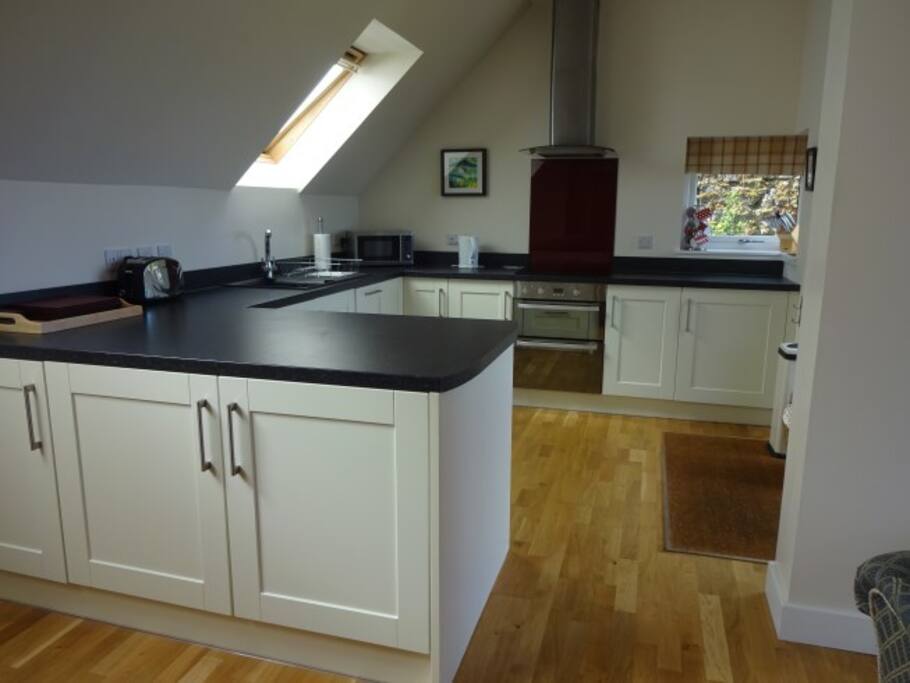Open plan kitchen complete with fridge, dishwasher and washing machine