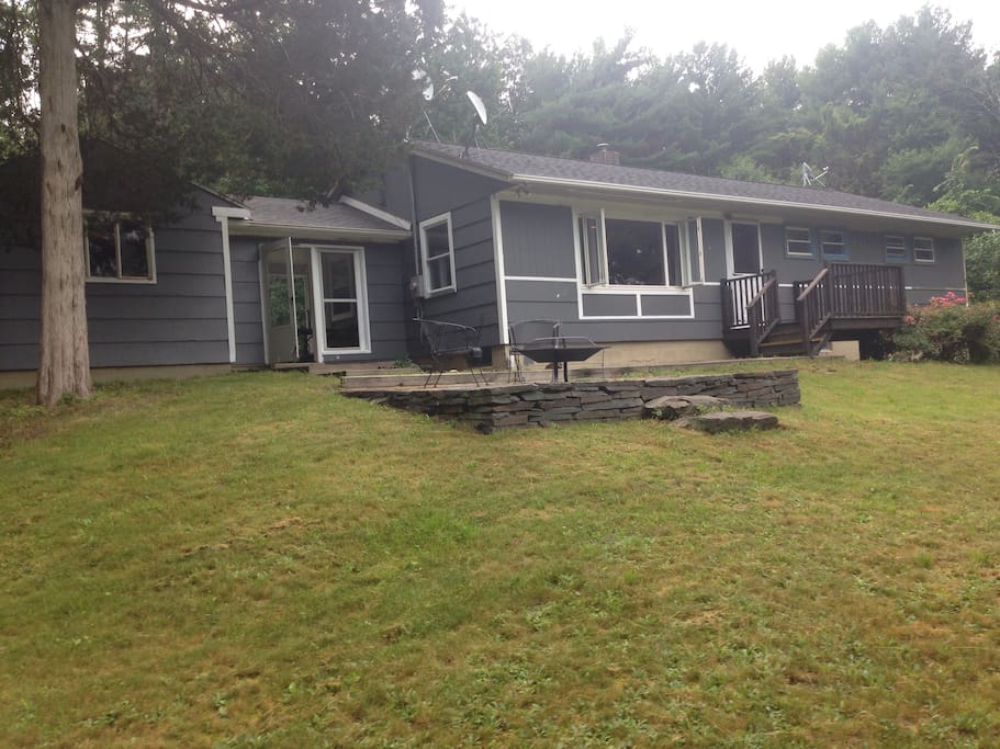 There is a deck and a patio with firepit.