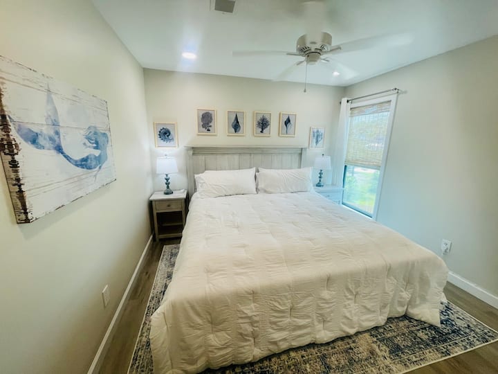 “Under the Sea” 2nd bedroom with king bed and view of Cotton Bayou’s abundant wildlife. This bedroom is “2nd” class with a chest of drawers, 42” 4K TV, and large closet. 