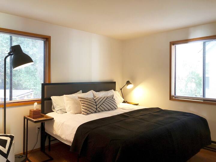 The Corner Suite located on the main floor features a king bed, two windows, and an en suite bath. It's on the shadier side of the house, great for afternoon naps!