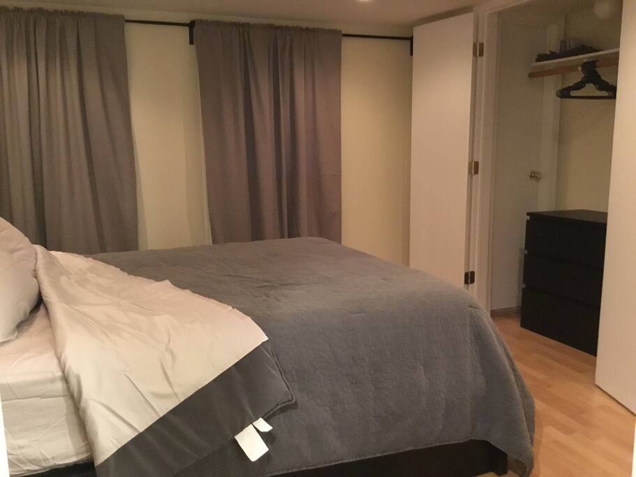 Master bedroom with queen size bed, wall mounted tv and spacious closets.