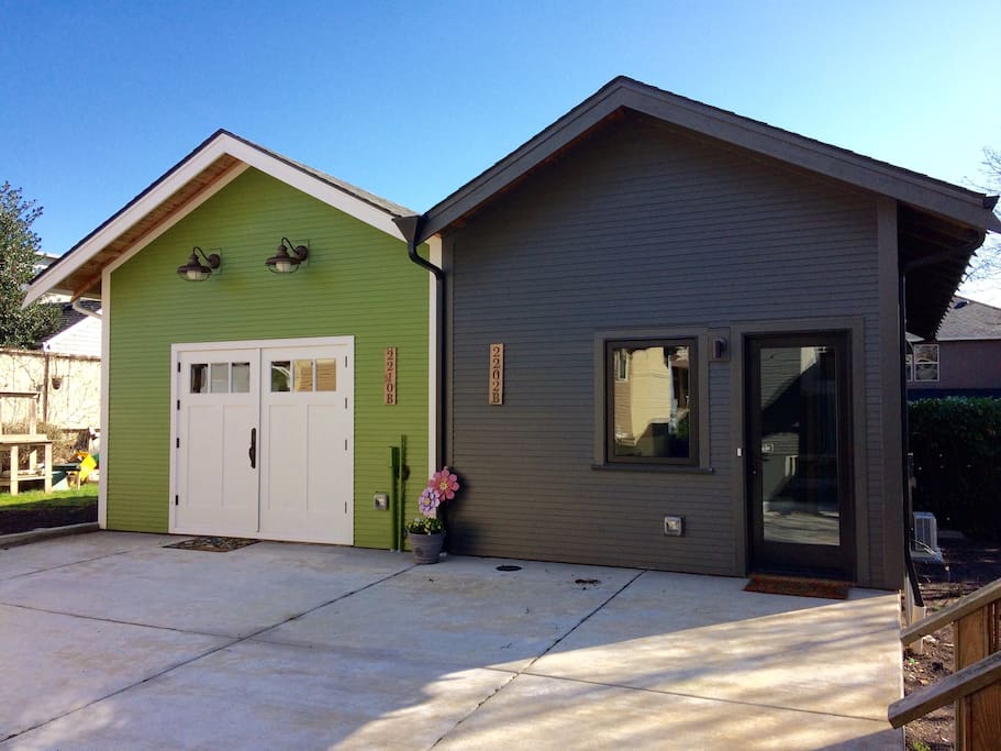 Street facing facade, concrete patio, and entry. Entry has full lite door and large bedroom casement window. Our unit is the gray colored (2202 B). We share a common wall at the property line with our neighbors unit (in green).